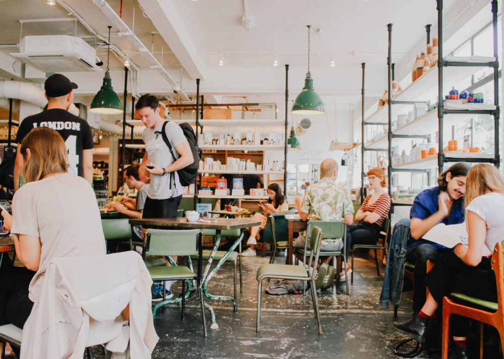 A lively café with customers talking at tables