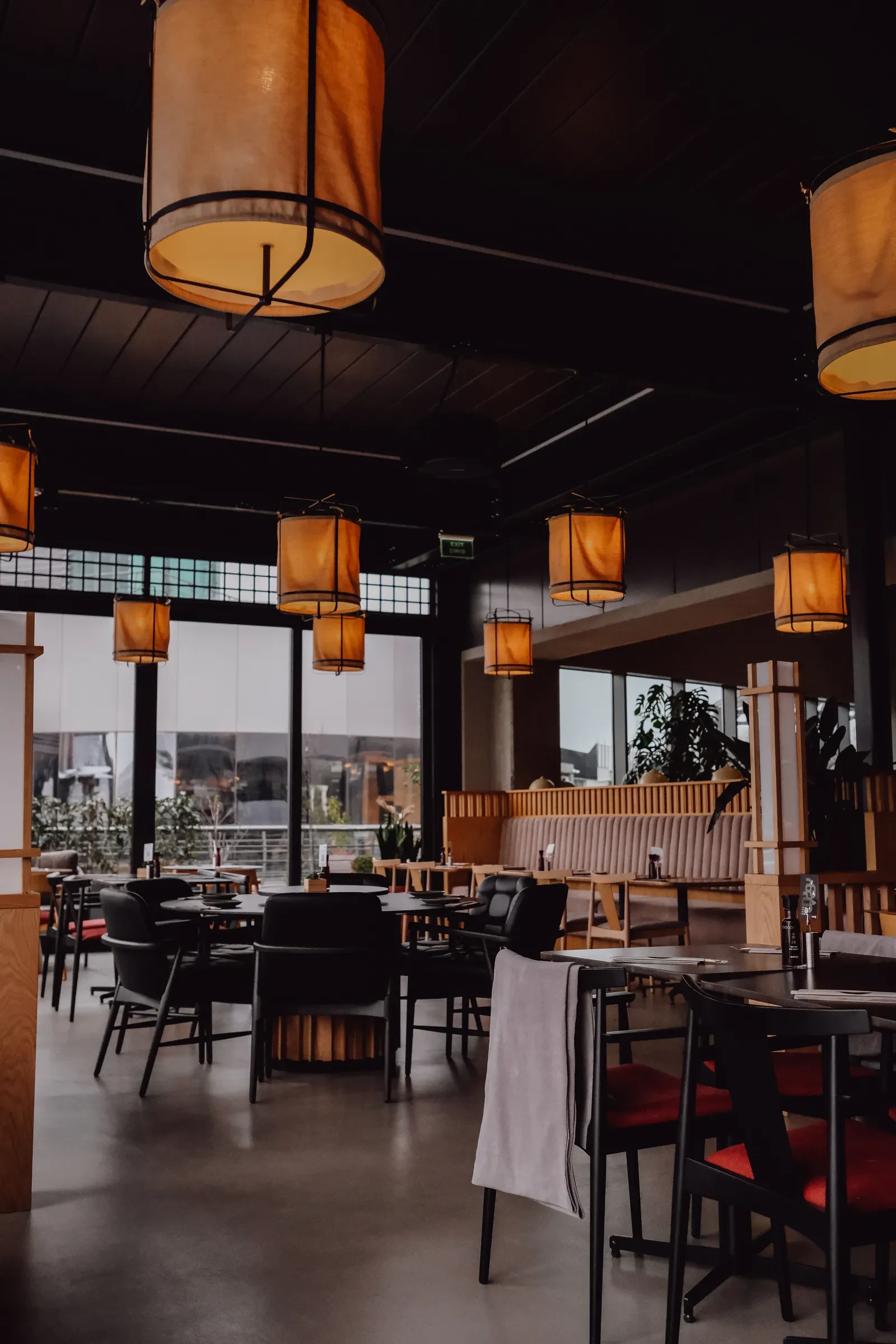 A warmly lit restaurant with empty tables during a quiet hour